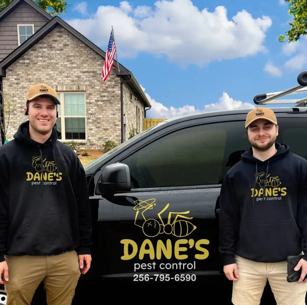 Dane's Pest Control Owners standing in front of a service truck
